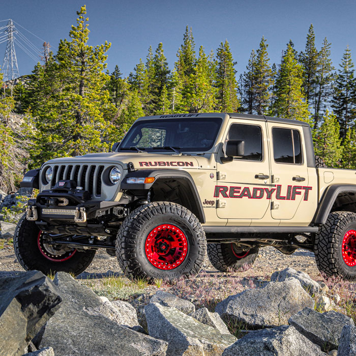 jeep / truck vehicle with red rims in the wilderness