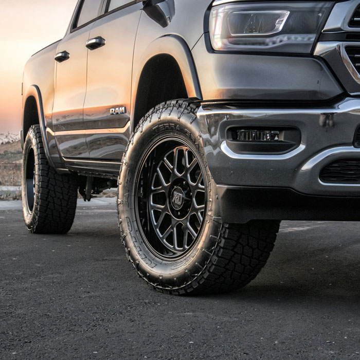 black truck with large tires and black rims