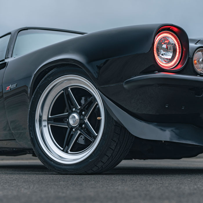 old school black car with chrome rims