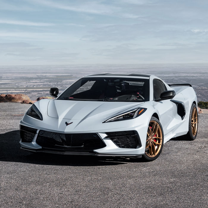 light grayish blue sports car with gold rims