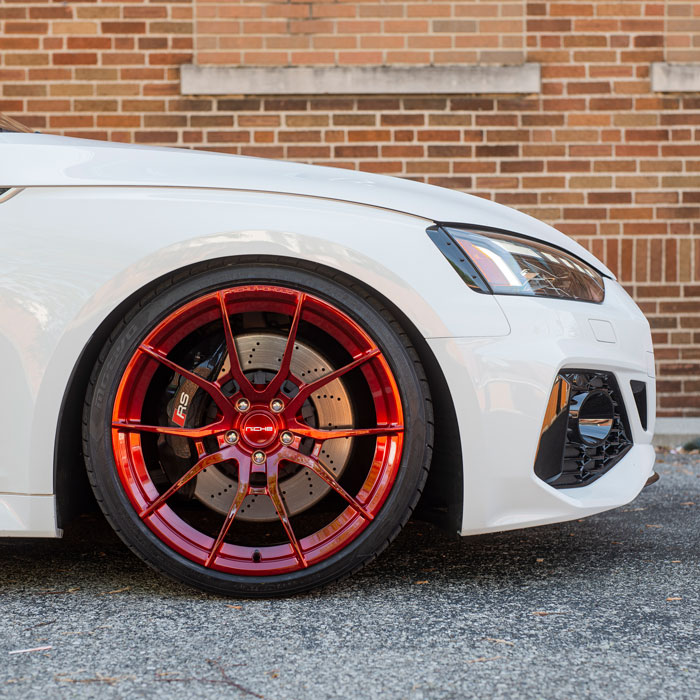 closeup of white car with red rims