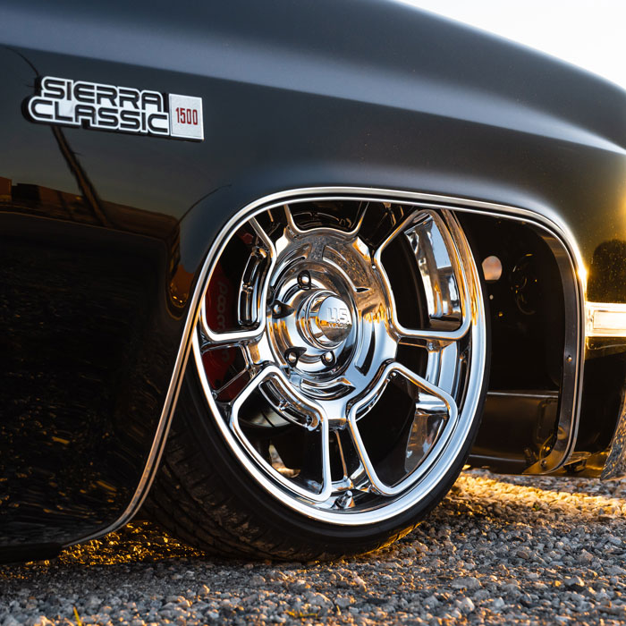 closeup of lowered car with chrome rims
